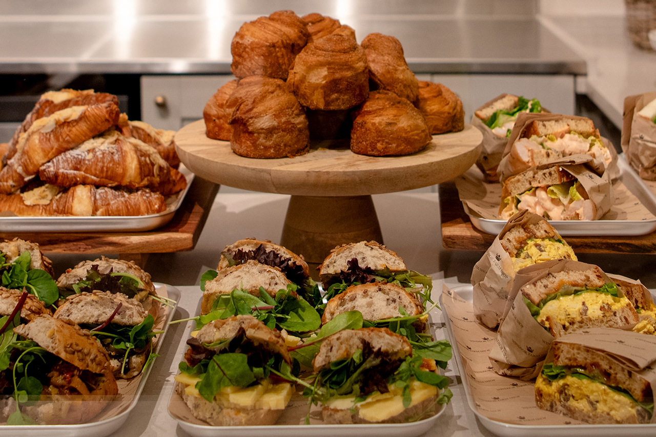 A display of sandwiches and cakes.