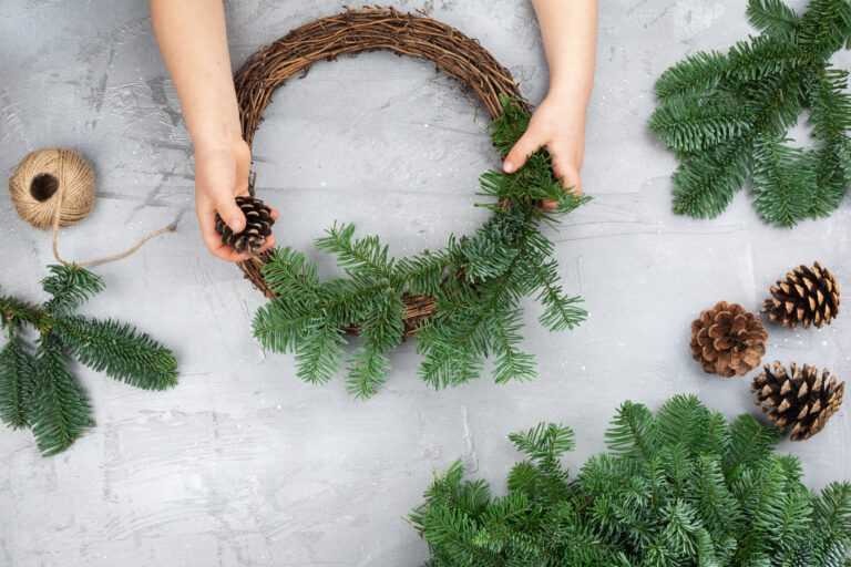 A child making a small Christmas wreath.