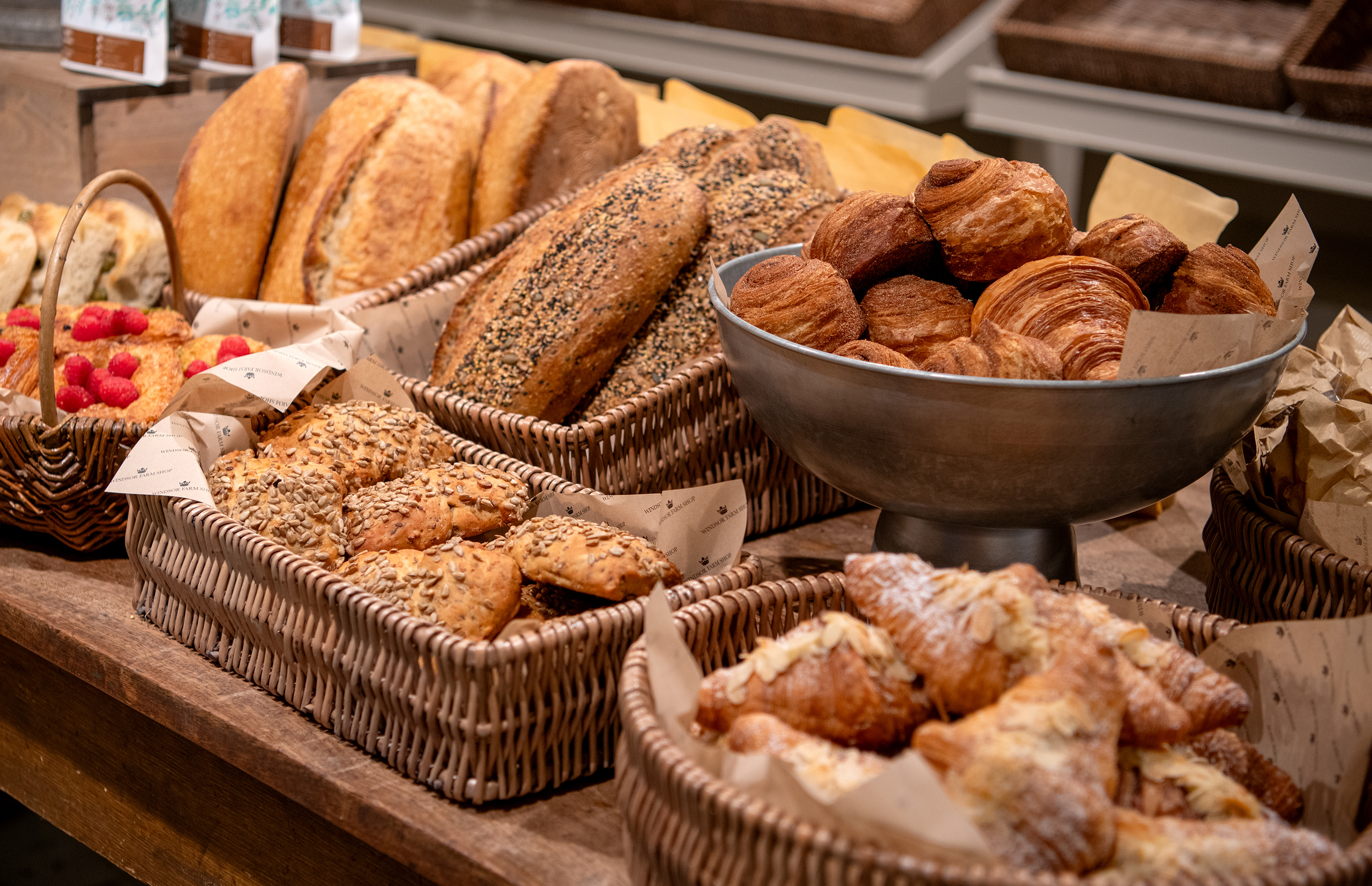 A display of breads in wicker baskets.