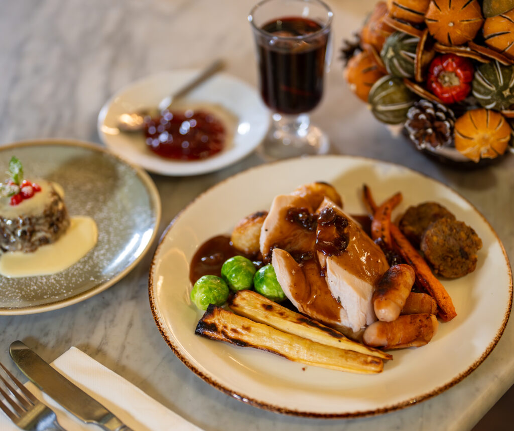 Christmas lunch with mulled wine, Christmas Pudding and table dressings.