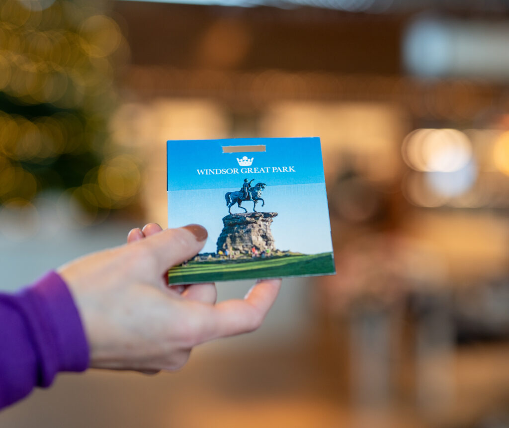 a close up of a hand holding a Windsor Great Park gift card.